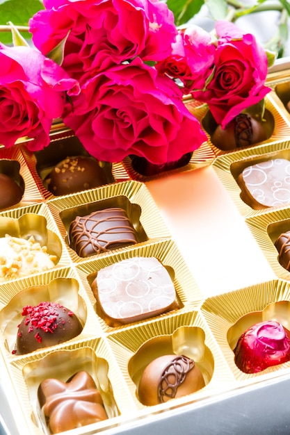 Gift box of assorted gourmet chocolate truffles on silver silk.