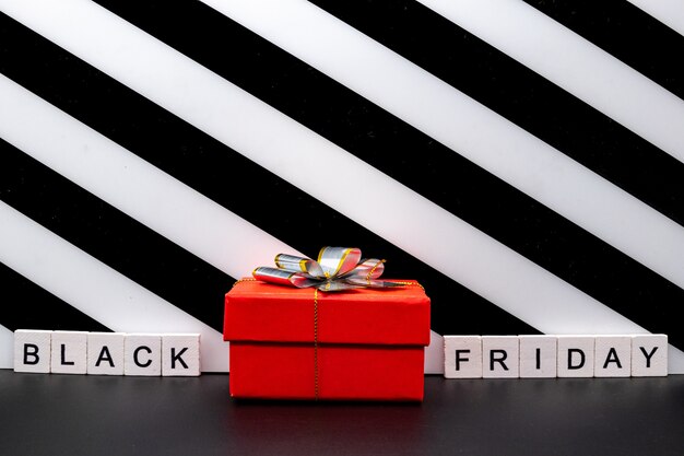 Gift box and black friday text on paper tear