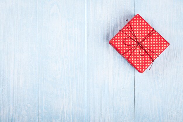 Gift box on blue wooden background