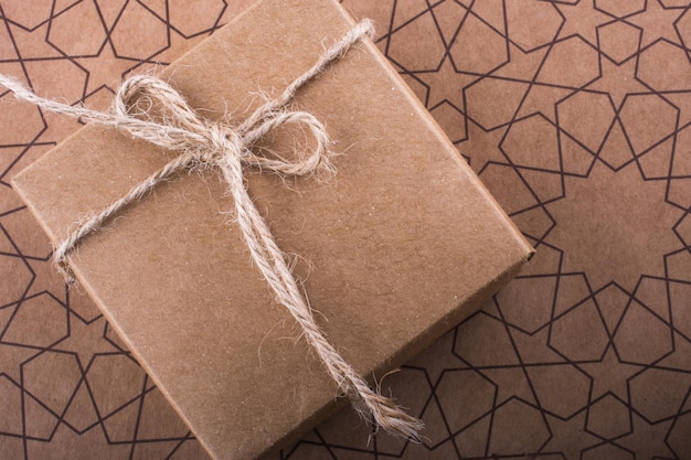 Gift box of brown color on a paper background