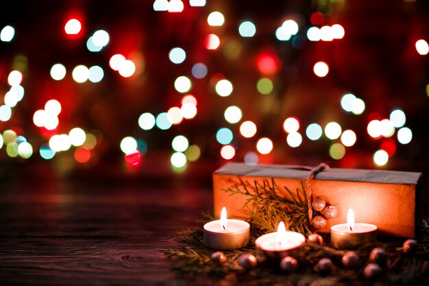 Gift box and candles with Christmas decorations