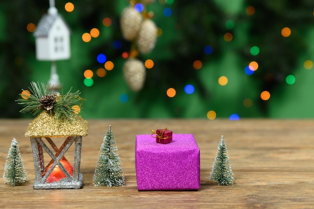 Gift box and christmas decor on wooden table bokeh effect copy space