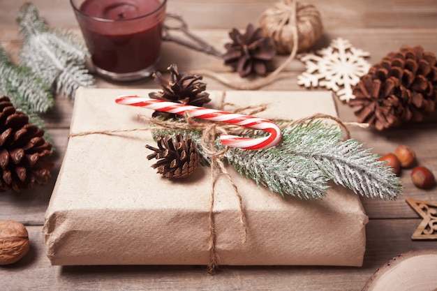 Gift box and Christmas decor on wooden table. 