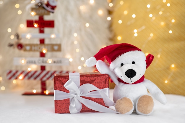 Gift box and christmas teddy on a bokeh