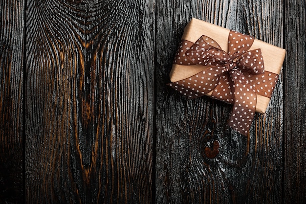 Gift box on dark wooden background