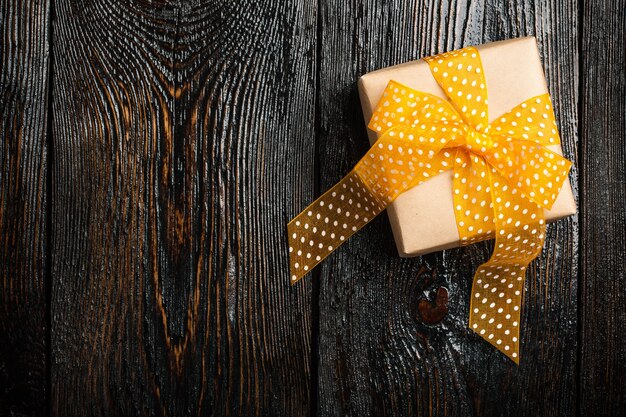 Gift box on dark wooden background