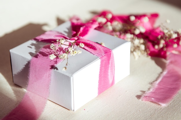 Gift box decoration with pink ribbon and dry flowers