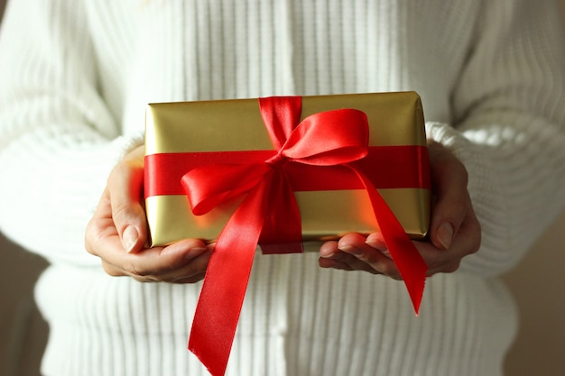 Gift box in female hands holiday give gift