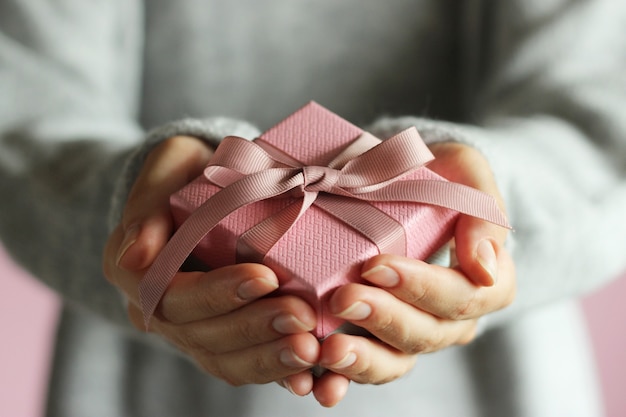 Gift box in female hands holiday give gift