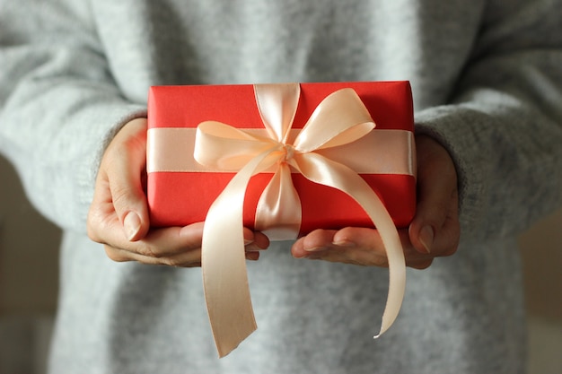 Gift box in female hands holiday give gift