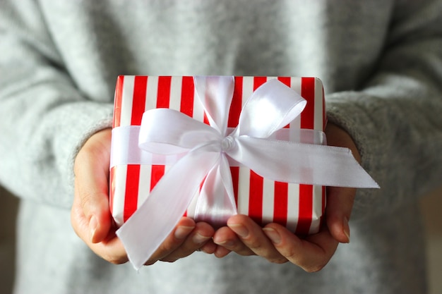 Gift box in female hands holiday give gift