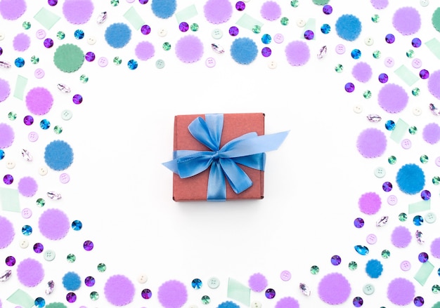 Gift box on festive pastel background.