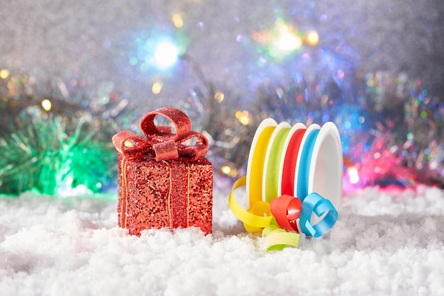 A gift box and gift ribbon on snow.