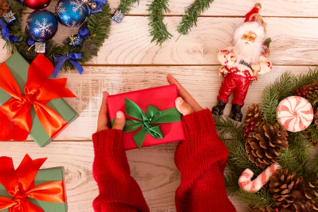 Gift box in girl's hands. Open presents. Christmas background