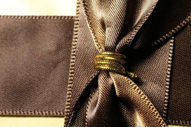 Photo gift box of golden color with brown ribbon