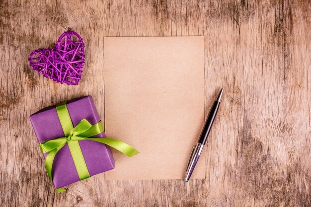 Gift box, greeting heart and  blank sheet of paper.