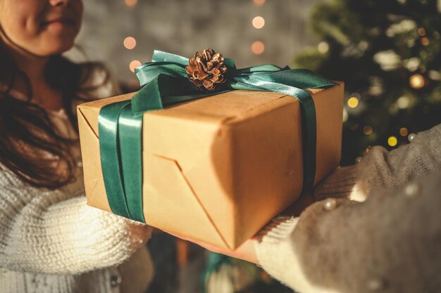 Photo gift box in the hands of mother and daughter christmas mood