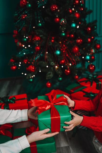 Gift box in the hands of mother and son Christmas mood