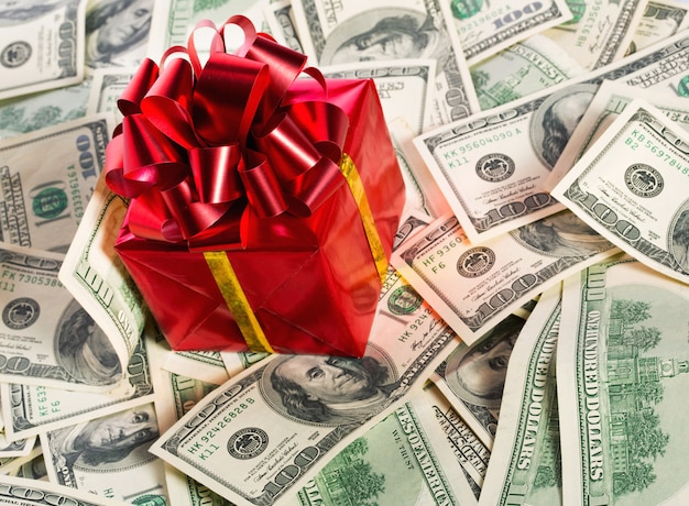 Photo gift box on heap of money