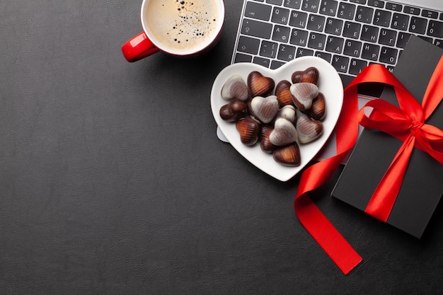 Gift box over laptop on office desk table