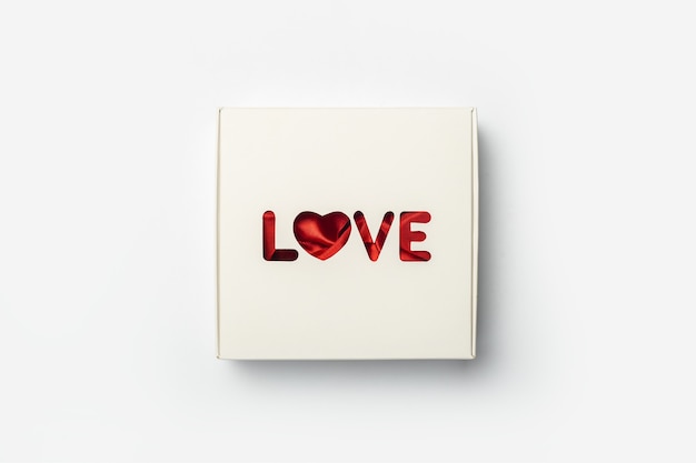 Gift box on a light white background. Composition Valentine's Day. Banner. Flat lay, top view.