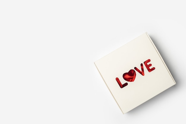 Gift box on a light white background. Composition Valentine's Day. Banner. Flat lay, top view.