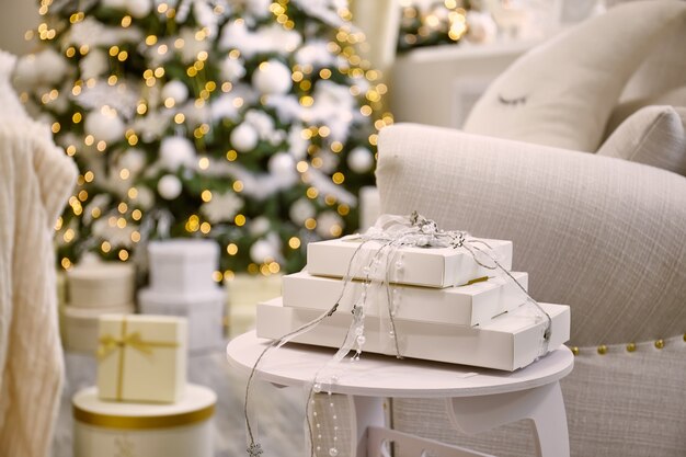 gift box near decorated christmas tree in living room