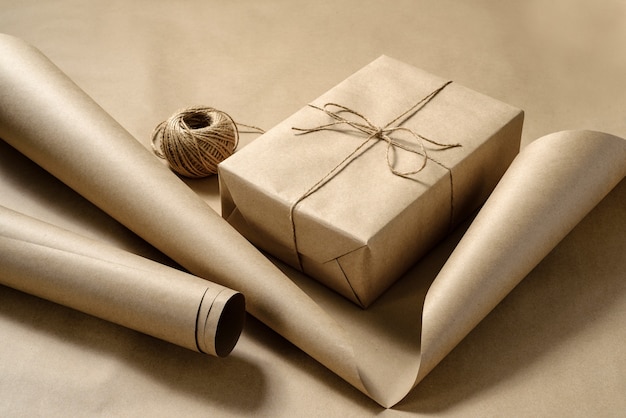 Gift box packing in craft paper. Craft paper, box, coil of twine.