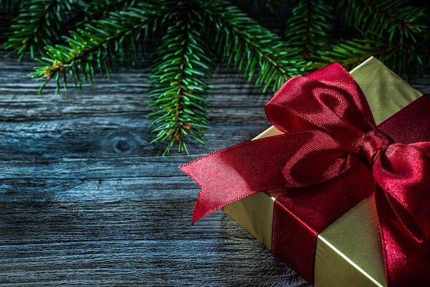 Gift box pine branch on wooden board