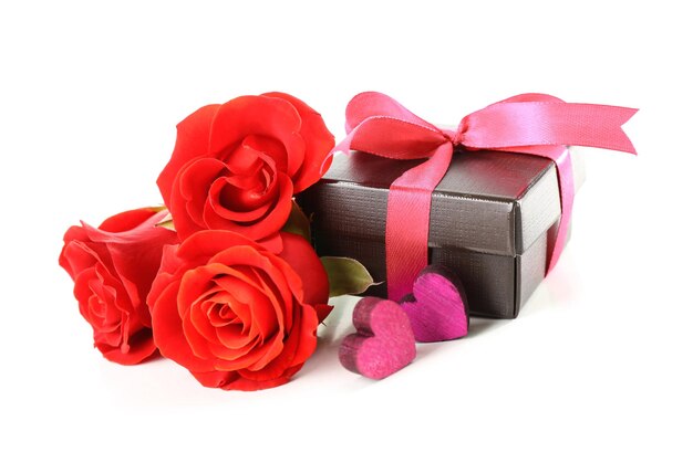 Gift box rose flowers and decorative heart isolated on white