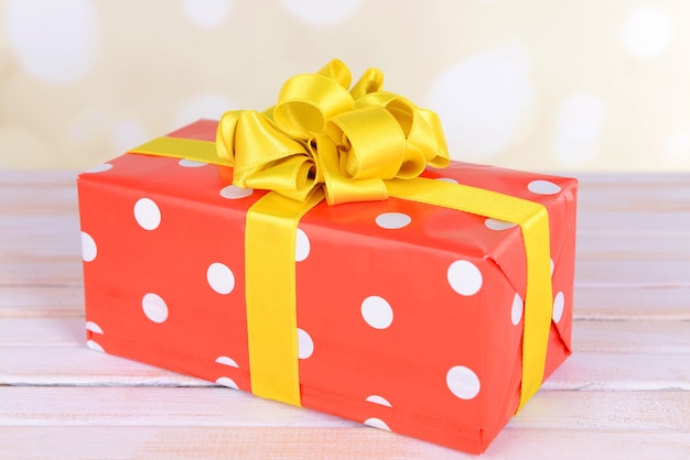 Gift box on table on light background