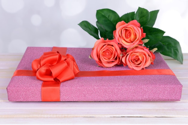 Gift box on table on light background