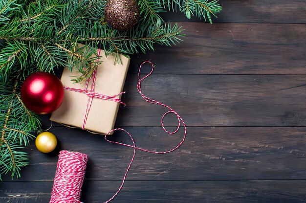 Gift box tied with a red ribbon fir branches