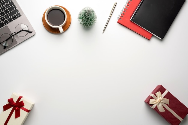 Gift box on a white desk. Christmas or New Year gift giving concept.