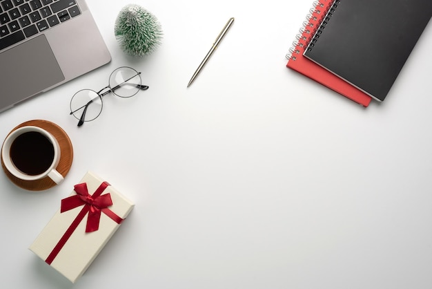 Gift box on a white desk. Christmas or New Year gift giving concept.