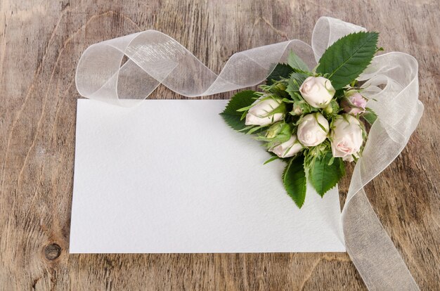 Gift box and white roses with empty card