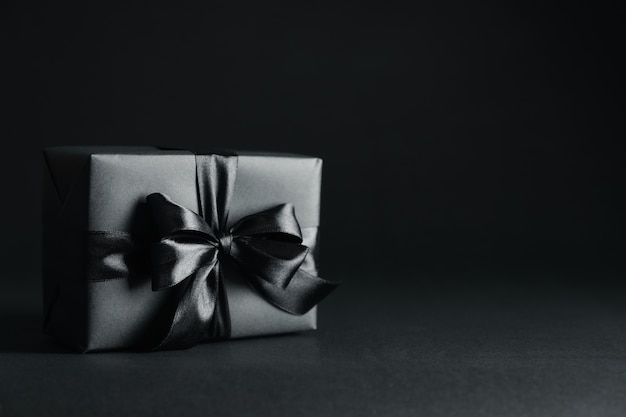 Gift box with black bow on black 