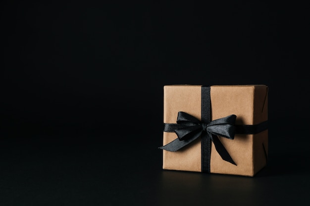 Gift box with black bow on black 