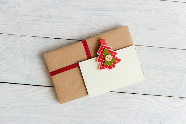 gift box with blank gift tag on white wooden background