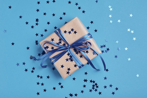 Gift box with bow and confetti, close up