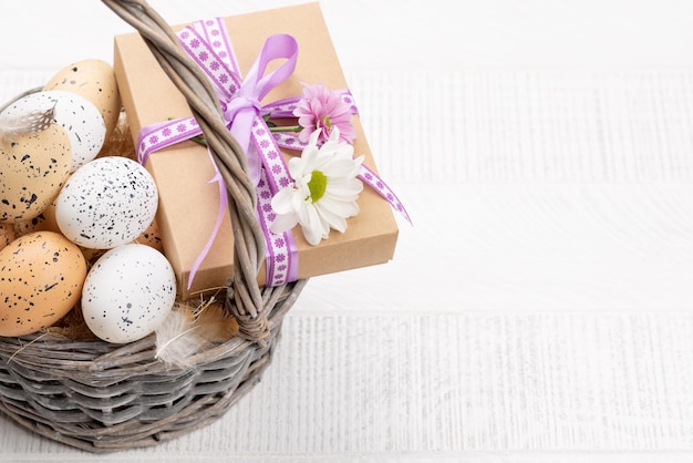 Gift box with flowers and Easter eggs basket