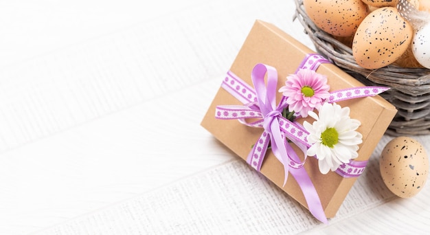 Gift box with flowers and Easter eggs basket