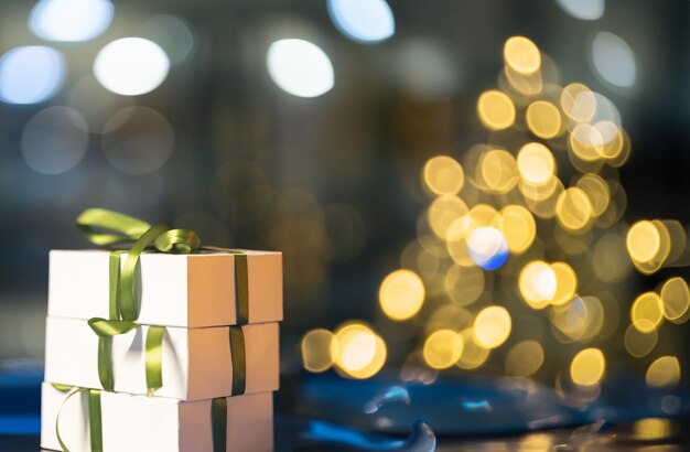 Gift box with green bow on table