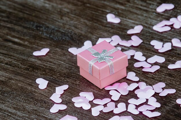 Photo gift box with hearts on a wooden