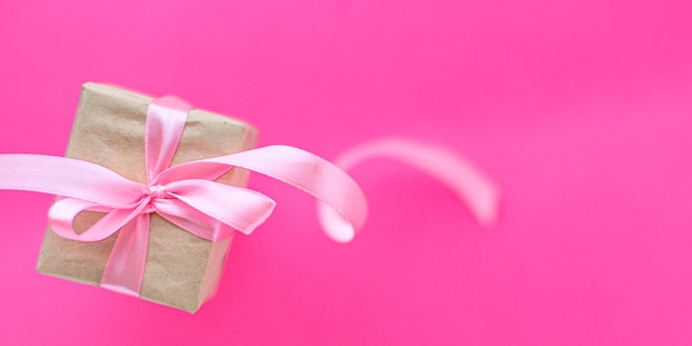 Gift box with pink ribbon. Copy space