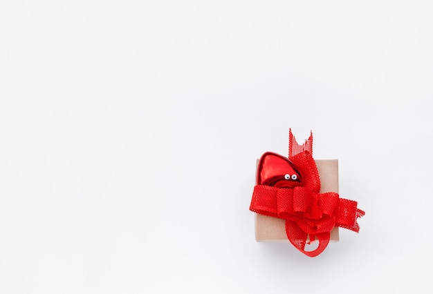 Gift box with red bows on the white surface