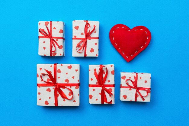 Gift box with red hearts on blue. top view