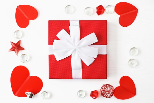 Gift box with red hearts on a white background