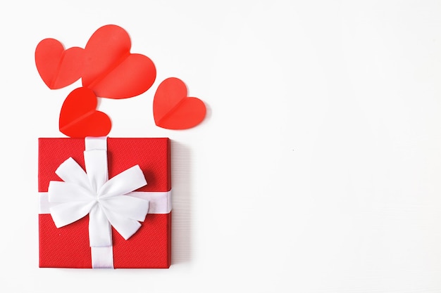 Gift box with red hearts on a white background