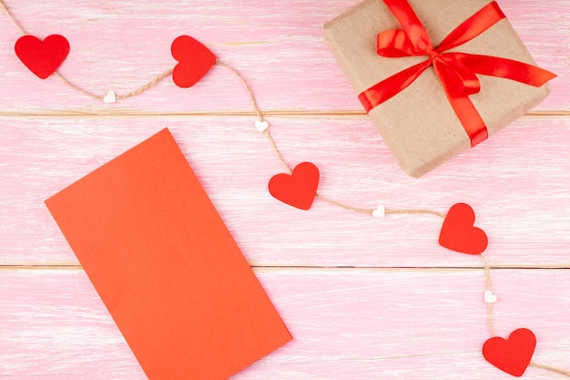 Gift Box with Ribbon Bow, Red Valentines Blank Card and Hearts on the Jute Rope